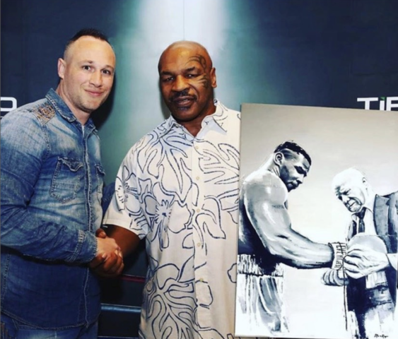 Marc van Rooijen giving a painting to Mike Tyson
